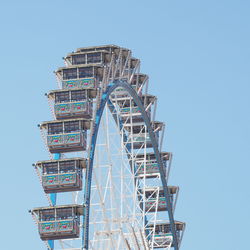 Low angle view of ferris wheel against clear sky