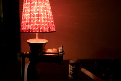 Close-up of illuminated lamp on table at home