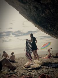 Rear view of woman standing on beach