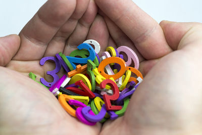 Midsection of person holding multi colored paper