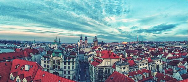 Cityscape against cloudy sky