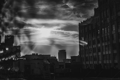 Buildings in city against sky at dusk