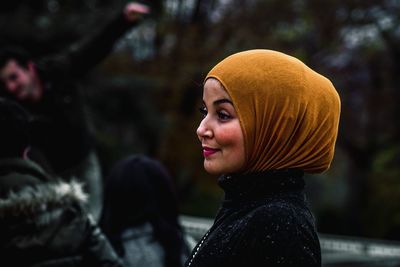 Portrait of young woman looking away outdoors