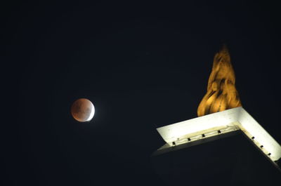 Low angle view of moon against sky at night