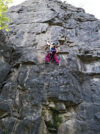 Low angle view of person standing on rock