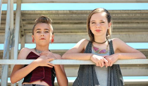 Portrait of a smiling girl sitting outdoors