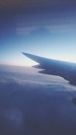 Cropped image of airplane flying over sea