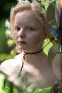 Close-up of girl looking away in a neon green handmade crown