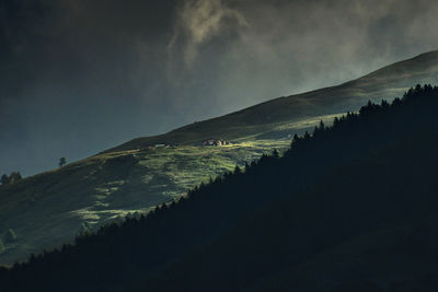 Scenic view of silhouette mountains against sky at dusk