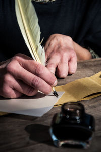 Close-up of hand writing a letter