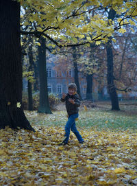 Boy walking on field during autumn