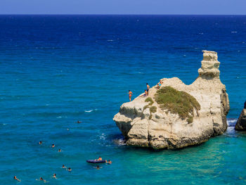 Scenic view of rock formation in sea against sky