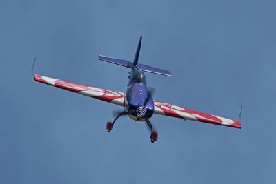 Low angle view of military airplane flying against sky