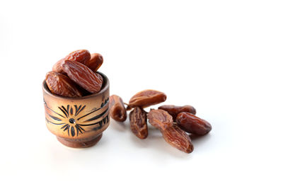Close-up of roasted coffee beans against white background