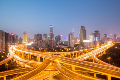 High angle view of illuminated city street and buildings at night