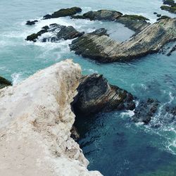 High angle view of rocks in sea against sky