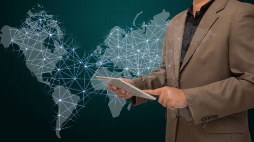 Digital composite image of businessman with world map