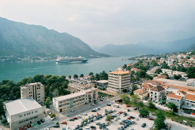 High angle view of townscape by sea against sky