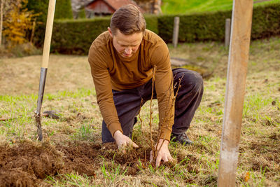 Man plants tree in the garden. nature, environment and ecology concept.