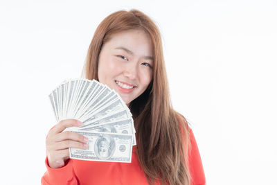 Portrait of a smiling young woman against white background