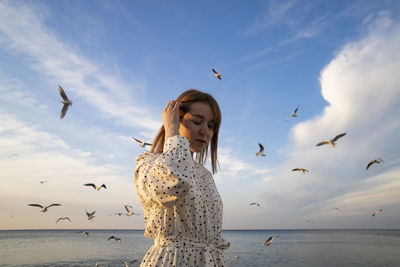 Low angle view of seagulls flying over sea against sky