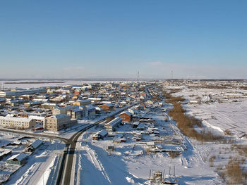 High angle view of buildings against clear sky during winter