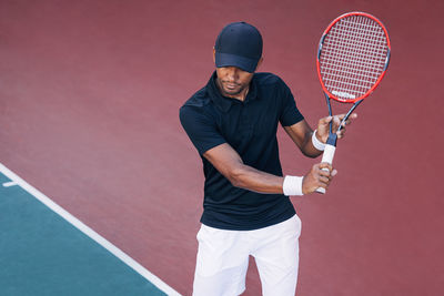 Midsection of man playing tennis