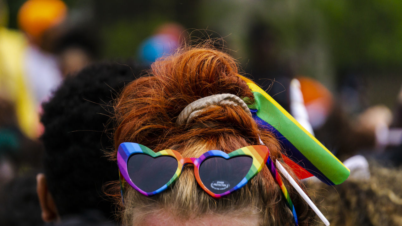 focus on foreground, multi colored, real people, women, hair, portrait, one person, headshot, hairstyle, glasses, day, close-up, adult, lifestyles, sunglasses, fashion, outdoors, incidental people, rear view, human hair, dyed hair, teenager