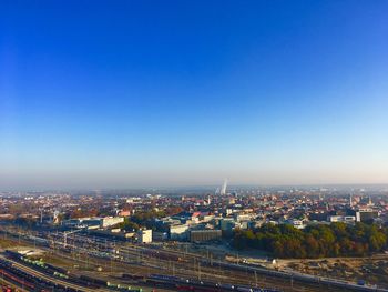 High angle view of buildings against clear blue sky