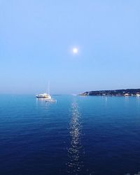 Sailboat sailing in sea against clear sky