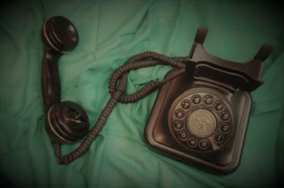 High angle view of old telephone on table