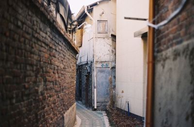 Empty alley amidst buildings in city