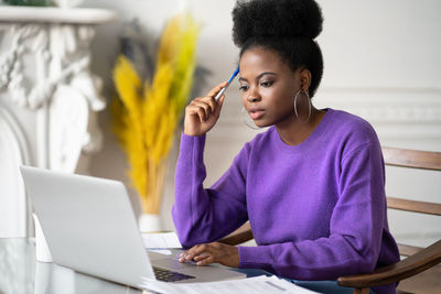 Young businesswoman brainstorming while sitting at office