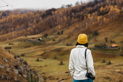 Rear view of woman standing on mountain