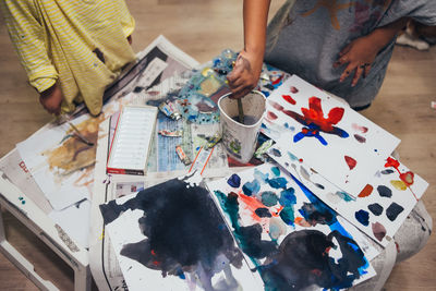 High angle view of children painting on table