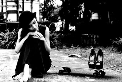 Portrait of woman sitting on street