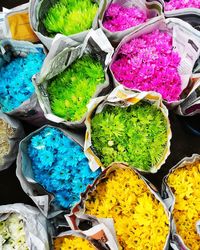 High angle view of multi colored vegetables for sale at market stall