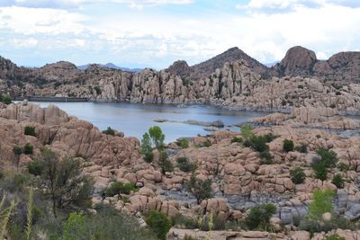 Panoramic view of rocks and bay against sky