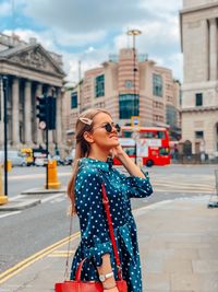 Woman standing on city street