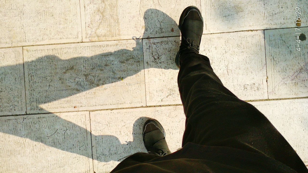 LOW SECTION OF MAN STANDING ON FLOORING