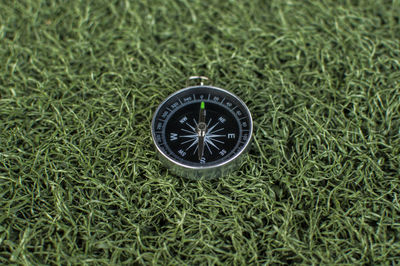 Close-up of navigational compass on field