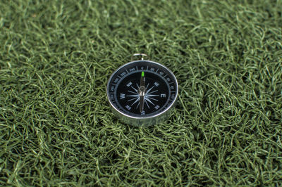 High angle view of clock on grass