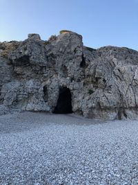 Rock formations against clear blue sky