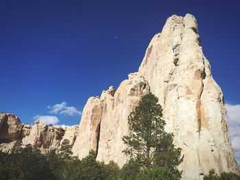 Low angle view of mountain against blue sky