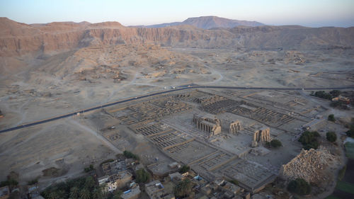 Aerial view medinet habu temple from hot air balloon with valley of the kings skyline luxor egypt