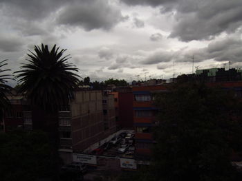 Buildings against cloudy sky