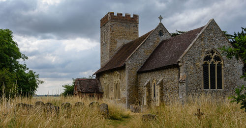 Old building on field against sky