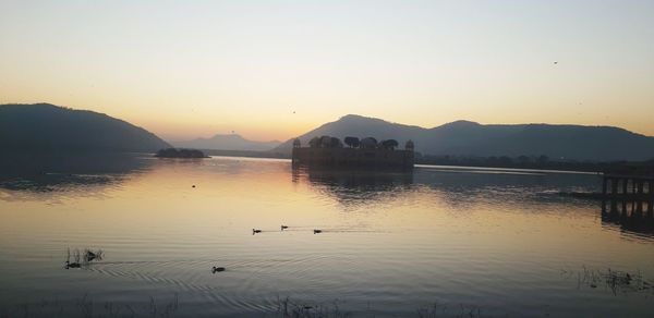 Scenic view of lake against sky during sunset