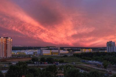 View of cityscape against cloudy sky