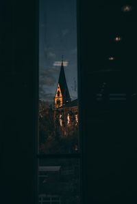 Buildings against sky seen through glass window